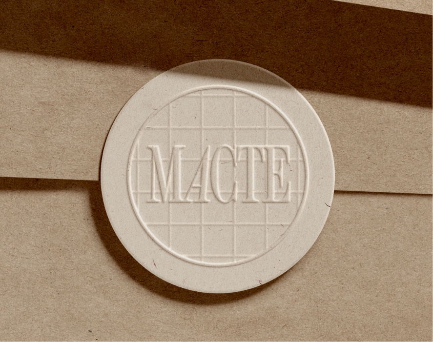 MACTE embossed sticker on a kraft paper envelope
