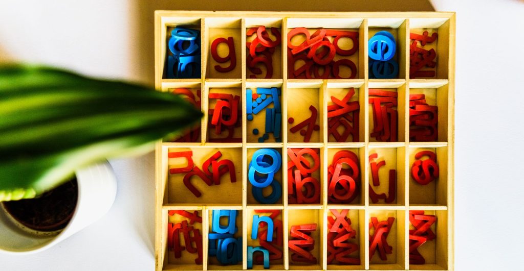 Organized box of blue and red letters at Montessori school